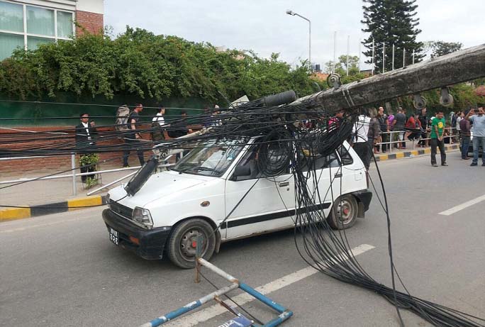 A car is hit by an electric pole after it collapsed following an earthquake in Kathmandu, Nepal. A magnitude-6.6 aftershock hit about an hour later, and smaller aftershocks continued to ripple through the region for hours.