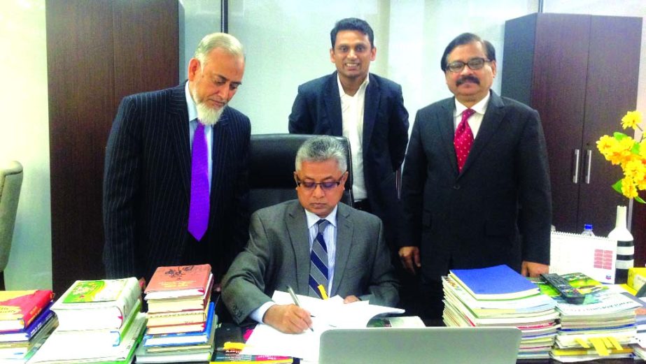 Nizam Chowdhury, Chairman of NRB Global Bank Ltd, signs the financial statements of 2014 recently. Md Abdul Quddus, Managing Director, RQM Forkan, Deputy Managing Director and Zillur Rahman, FCA, Head of Finance & Accounts Division of the bank were presen