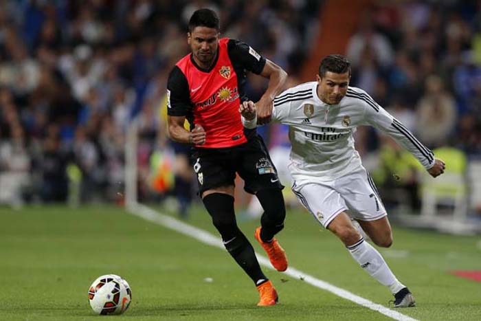 Real Madrid's Cristiano Ronaldo (right) duels for the ball with Mauro Javier Dos Santos from Argentina during a Spanish La Liga soccer match between Real Madrid and Almeria at the Santiago Bernabeu stadium in Madrid, Spain on Wednesday.
