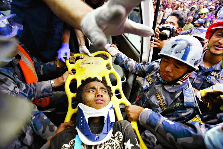 Earthquake survivor Pema Lama, 15, is rescued by the Armed Police Force from the collapsed Hilton Hotel, five days after an earthquake in Kathmandu, Nepal on Thursday.