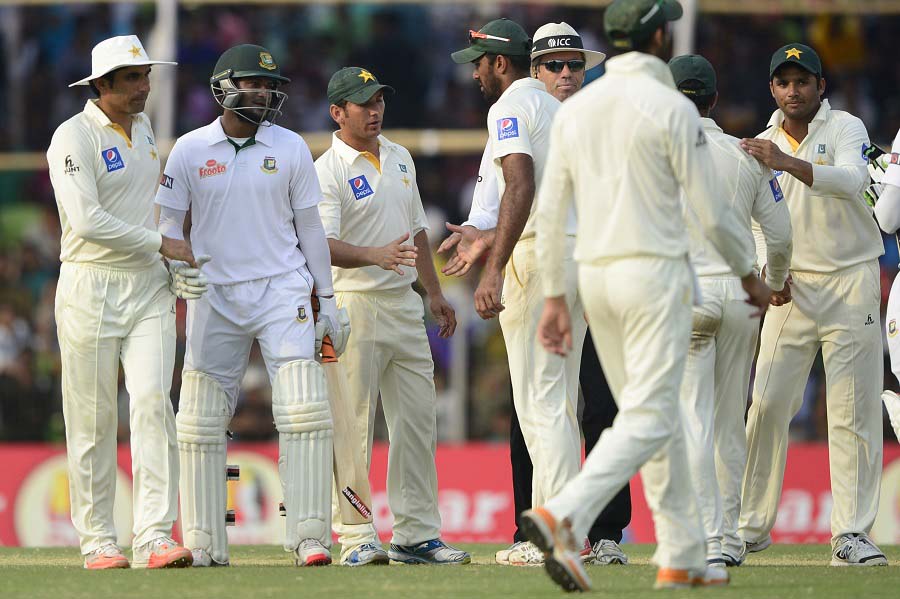 Bangladesh cricketer Shakib Al Hasan (2L) shakes hands with Pakistan captain Misbah-ul-Haq (L) at close of play on the fifth and final day of the first Test match between Bangladesh and Pakistan at the Sheikh Abu Naser Stadium in Khulna on Saturday. Tamim