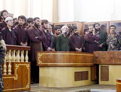 Defendants attend their trial at the Primary Court in Kabul on Saturday.