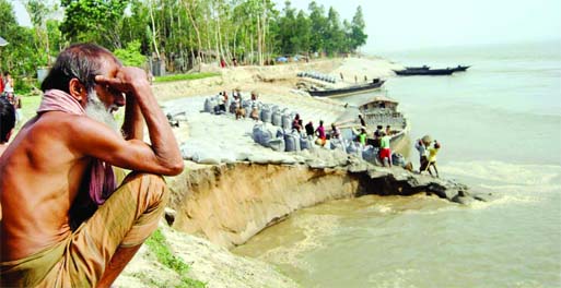 Work on Jamuna River embankment protection project continued at Dhunate in Bogra despite being damaged badly by heavy rush of current on Sunday morning. This photo was taken from Koiyagari Upazila area.