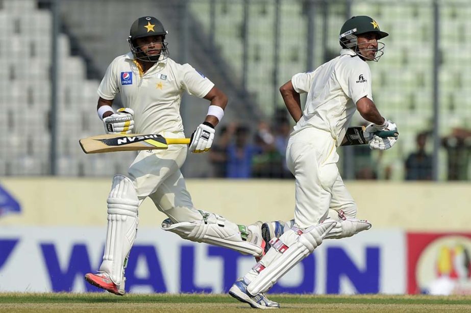 Pakistani cricketer Younis Khan (R) and teammate Azhar Ali (L) run between the wickets during the first day of the second cricket Test match between Bangladesh and Pakistan at the Sher-e-Bangla National Cricket Stadium in Mirpur on Wednesday.