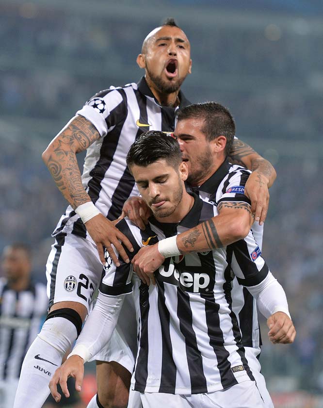 Juventus' Alvaro Morata (foreground) celebrates with teammates Arturo Vidal (top) and Stefano Sturaro after scoring the opening goal during the Champions League semifinal match between Juventus and Real Madrid at the Juventus Stadium in Turin, Italy on T