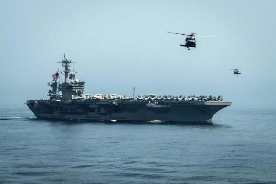 Photo shows helicopters flying from the US aircraft carrier USS Theodore Roosevelt in the Gulf of Oman.