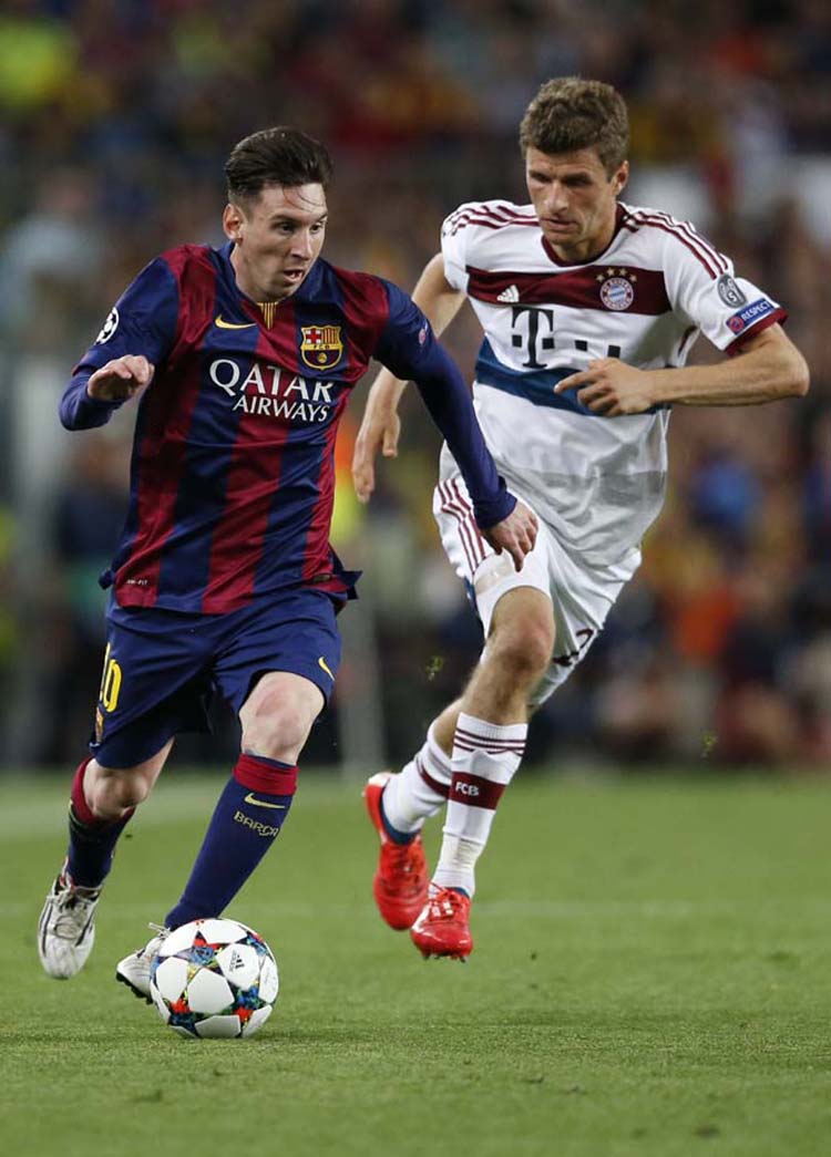 Barcelona's Lionel Messi (left) is followed by Bayern's Thomas Mueller as he goes downfield during the Champions League semifinal first leg soccer match between Barcelona and Bayern Munich at the Camp Nou stadium in Barcelona, Spain on Wednesday.