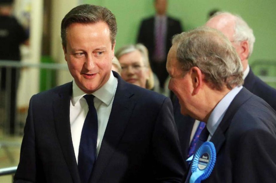 British Prime Minister and Conservative Party leader David Cameron (L) talks to supporters at the Windrush Leisure Centre, Witney, north west of London on Thursday.