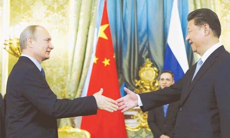 Russian President Vladimir Putin, left, shakes hands with his Chinese counterpart Xi Jinping during their meeting in Moscow's Kremlin, Russia, on Friday.