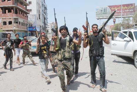 Fighters loyal to Yemen's Saudi-backed President Abedrabbo Mansour Hadi patrol a main street in the Dar Saad suburb of the southern port city of Aden.