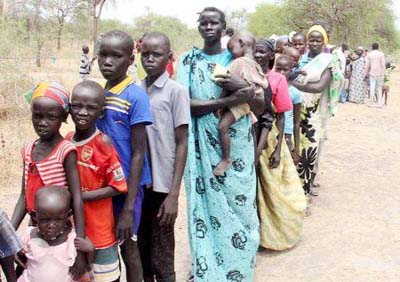 Residents displaced due to the recent fighting between government and rebel forces in the Upper Nile capital Malakal wait at a World Food Program (WFP) outpost where thousands have taken shelter in Kuernyang Payam, South Sudan