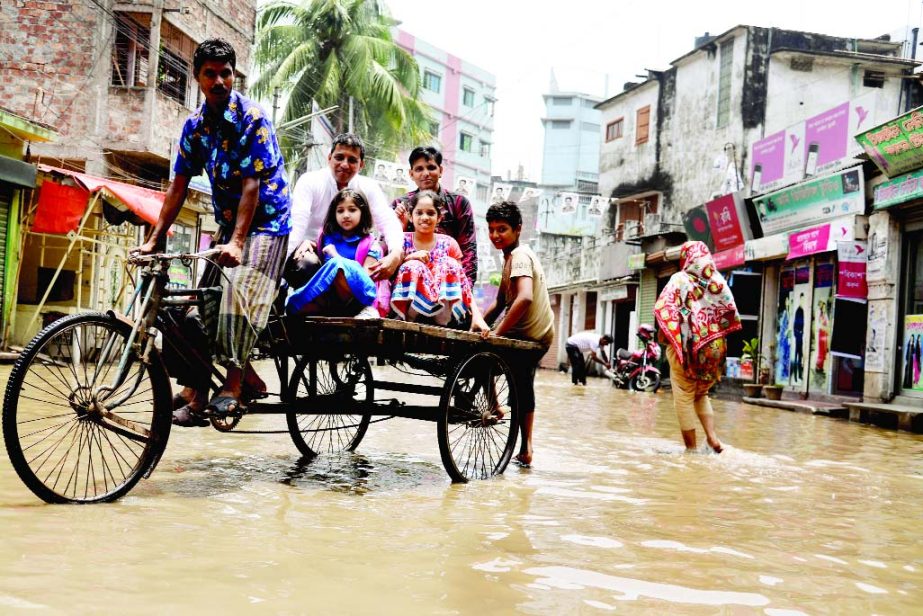 Heavy rainfall creates water-logging in city due to poor drainage system causing sufferings to movement of vehicles and dwellers. This photo was taken from Kayethtuly area in old part of Dhaka on Monday.