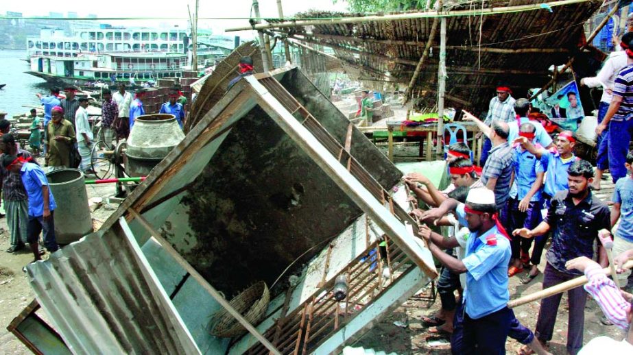 Illegal structures on the bank of river Buriganga being evicted jointly by BIWTA and DMP on Monday as directed by the High Court.