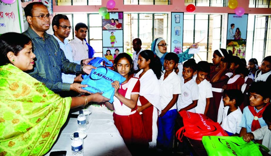 Deputy Commissioner of Dhaka Tofazzal Hossain Miah distributing education materials among the students of Khodeza Khatun Government Primary School in the city's Bangla Motor area at a ceremony organized by Bangladesh Scouts, Dhaka Metropolitan on Tuesday