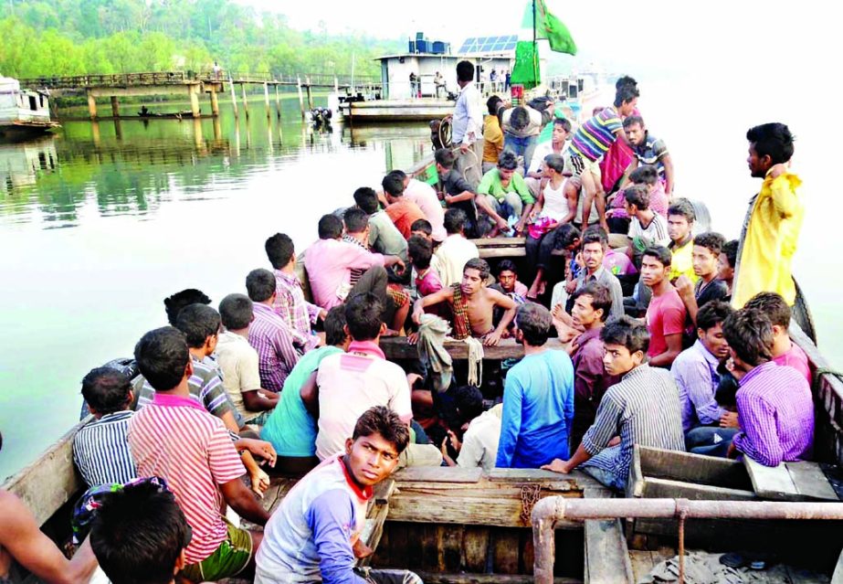 Members of Bangladesh Navy and Coast Guard brought about 116 illegal Bangladeshi migrants to the shore after they were found floating on a wooden boat near Teknaf coast on Wednesday. Photo- Banglar Chokh