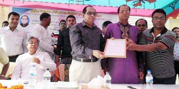 Chairman of Sadar Union Parishad Molla Mosharrof Hossain Mofiz giving away a letter of welcome to State Minister for Youth and Sports Biren Sikder at the proposed area of Dumuria Stadium in Dumuria Upazila under Khulna district recently.