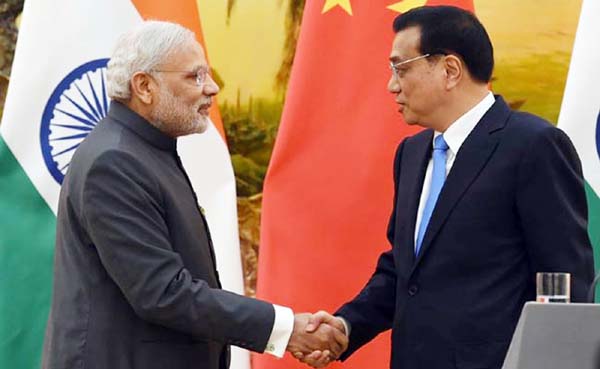 Prime Minister Narendra Modi shakes hands with Chinese Premier Li Keqiang after a joint press conference in the Great Hall of the People in Beijing.