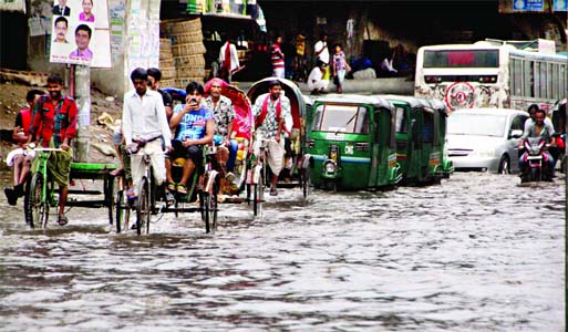 Sudden downpour with severe thunderbolts flooded the city streets causing sufferings to commuters as well as pedestrians for several hours. This photo was taken from near Bangabhaban on Friday.