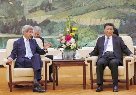 US Secretary of State John Kerry (L) talks with Chinese President Xi Jinping at the Great Hall of the People in Beijing, China on Sunday.