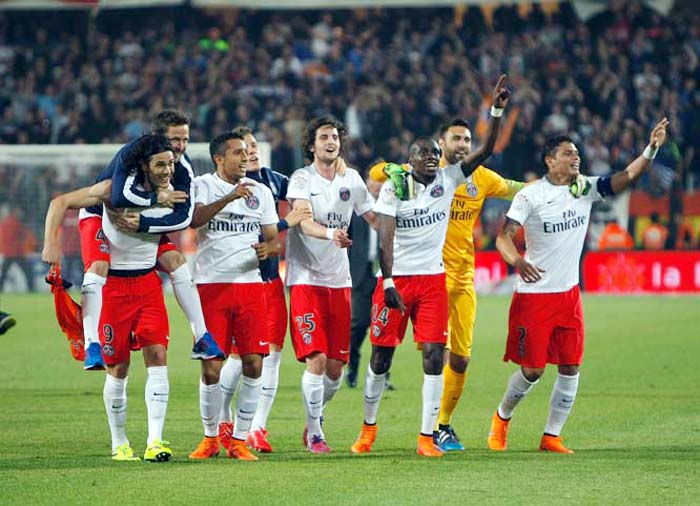 Paris Saint-Germain players celebrate after defeating Montpellier and winning the French League One title at the end of the League One soccer match between Montpellier and Paris Saint-Germain, at the La Mosson Stadium, in Montpellier, southern France on