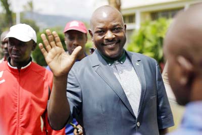 President Pierre Nkurunziza waves as he walks to his car after making a brief statement to the media at the presidential palace in Bujumbura, Burundi on Sunday.