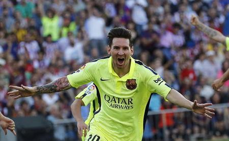 Barcelona's Lionel Messi celebrates his goal against Atletico Madrid during their Spanish first division soccer match at Vicente Calderon stadium in Madrid, Spain on Sunday.