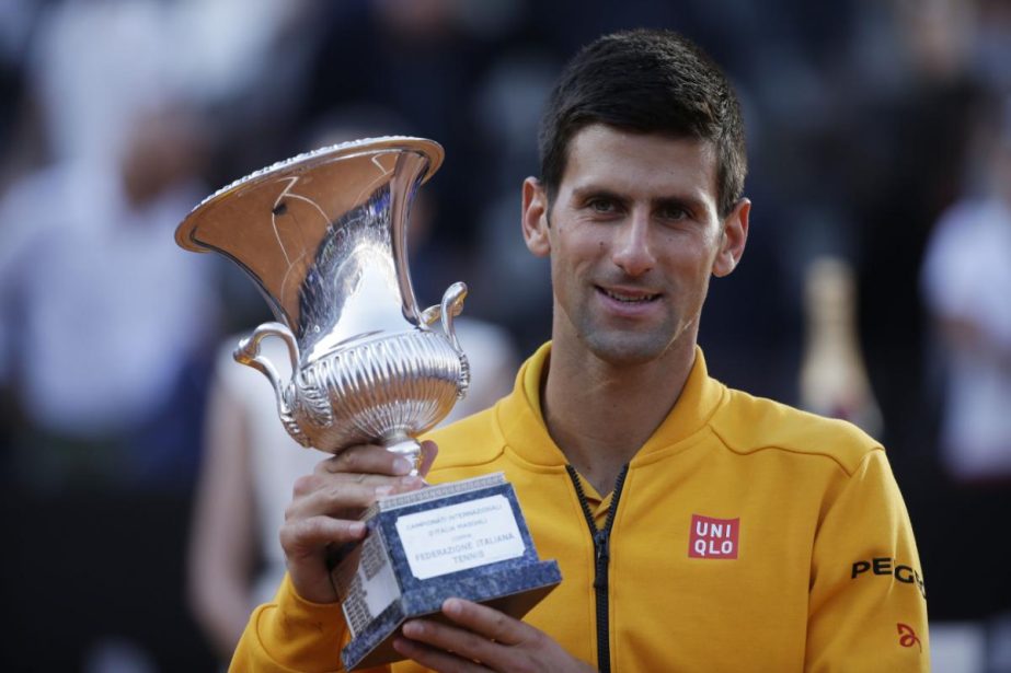 Serbia's Novak Djokovic poses the cup he received after winning the final match at the Italian Open tennis tournament, in Rome on Sunday.