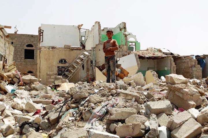 A Yemeni boy stands amidst the rubble of houses destroyed by Saudi-led air strike on a residential area last month, in the capital Sanaa on Monday.