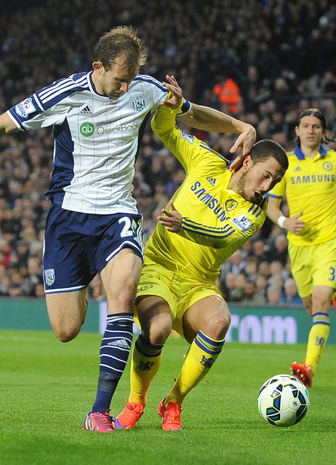 Chelsea's Eden Hazard, right, vies for the ball with West Brom's Craig Dawson during the English Premier League soccer match between West Bromwich Albion and Chelsea at the Hawthorns, West Bromwich, England on Monday.