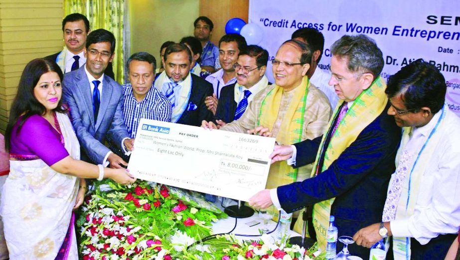 BB Governor Dr Atiur Rahman and Md Arfan Ali, DMD of Bank Asia, handing over SME Loan Disbursement Cheque to Sarnalata Roy, a woman entrepreneur of the bank, in Sylhet town recently. European Union Ambassador Pierre Mayaudon was present.