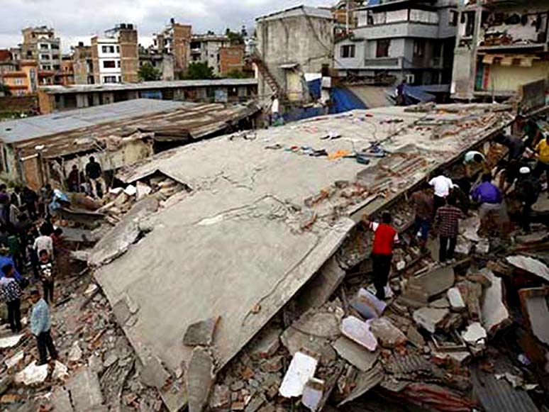People gather near a collapsed house after a major earthquake in Kathmandu in Nepal on April 25.