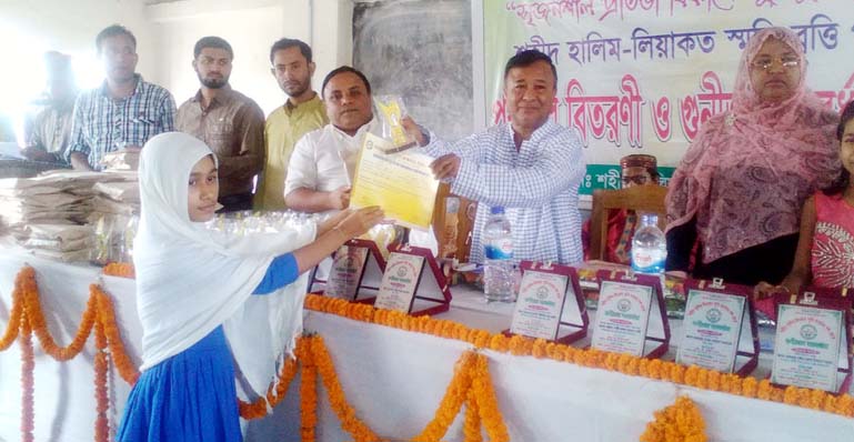 Chakaria Upazila Parishad Chairman Jafar Alam distributing prizes among the meritorious students of Shaheed Halim Liakat Smriti Scholarship distributing ceremony at Chakaria in Chittagong yesterday.