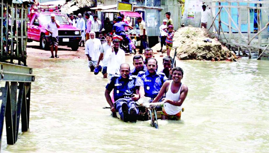 Bailey Bridge of three ferry ghats on Kalapara-Kuakata Highway being submerged and washed away by rising tidal waters disrupting movement of vehicles. This photo was taken from Nilganj Ferry Ghat on Wednesday.