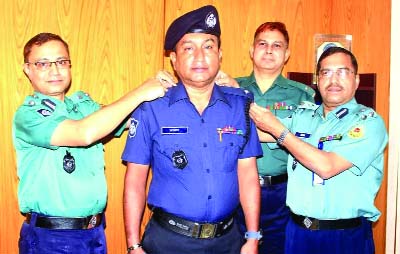 KHULNA: KMP Commissioner Nibas Chandra Maghi adoring rank badge to newly promoted Inspector Manos Rajon Das at a function recently.