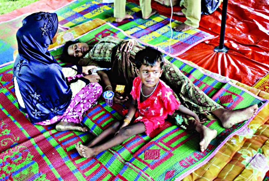 A Rohingya young girl cries next to her sick mother at a temporary shelter in Bayeun, Aceh province, Indonesia on Thursday.