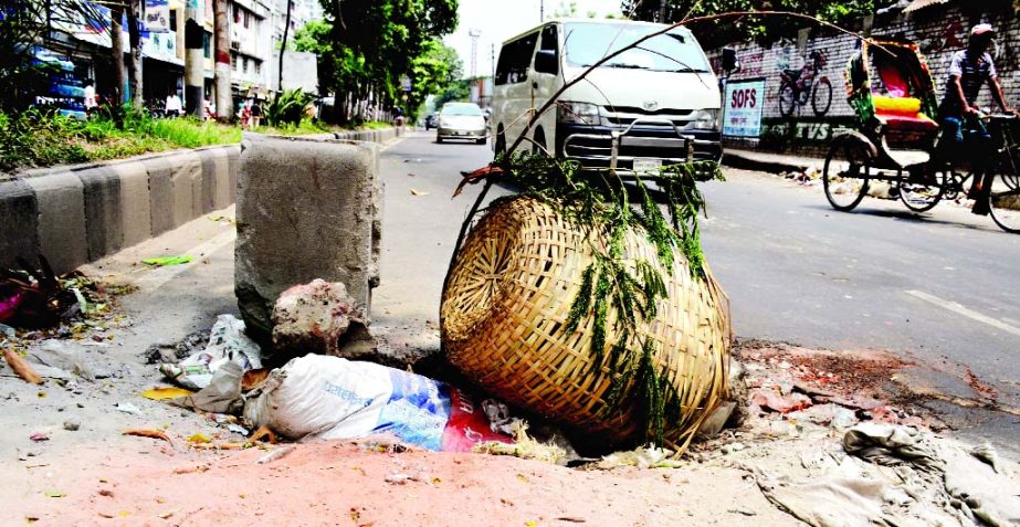 Wastes were kept dumped on a big pothole that developed at the main thoroughfare of city's Kamalapur area threatening serious accident anytime. This photo was taken on Thursday.
