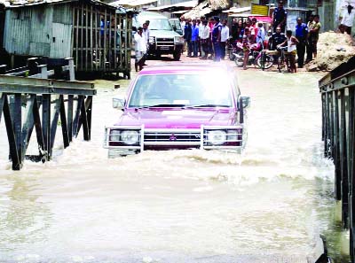 PATUAKHALI: Bailey bridge on Kalapara - Kuakata highway went under water as water level has risen in the river . This picture was taken on Thursday.