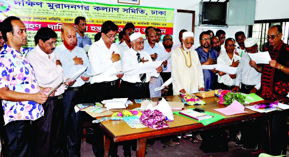 Newly elected office-executives of Dakshin Muradnager Kalyan Samity, Dhaka taking oath of office at Purta Bhaban in the city on Saturday. Among others, senior journalist of the New Nation Alamgir Khan was present at the oath taking ceremony.