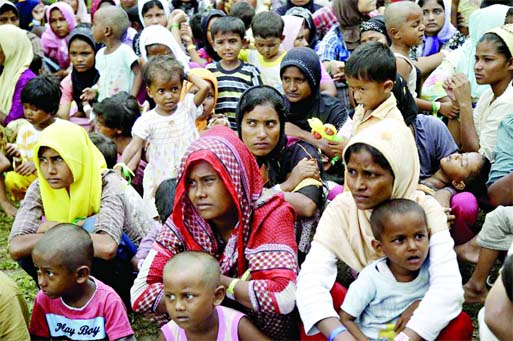 Ethnic Rohingya women and children gather to receive meal at a temporary shelter in Bayeun, Aceh province, Indonesia on Saturday.