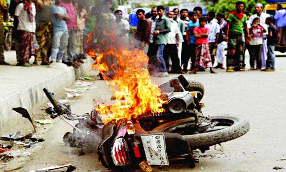 A motor-bike of a man who assaulted a teacher of Dhaka University Prof Mizanur Rahman was torched in front of DU Shahidullah Hall on Sunday by the students of the university in retaliation.