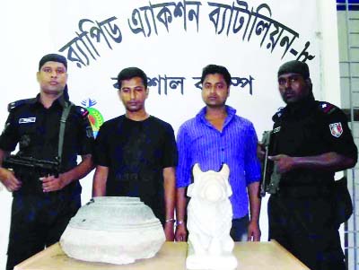 BARISAl: Members of RAB-8 arrested two persons with two touch-stone statues worth about Tk three crore from Barisal recently.