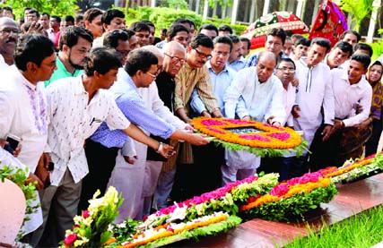 Awami League leaders and activists paying tributes to National Poet Kazi Nazrul Islam by placing floral wreaths on his grave in the city on Monday marking the 116th birth anniversary of the Poet.