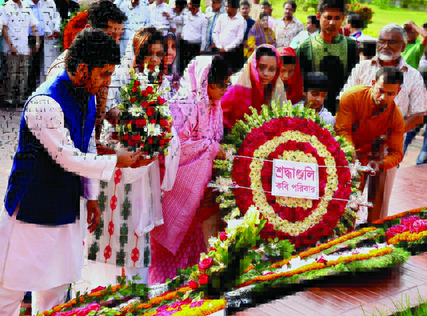 Marking the 116th birth anniversary of National Poet Kazi Nazrul Islam family members placing wreaths on the Poet's Mazar in city on Monday.