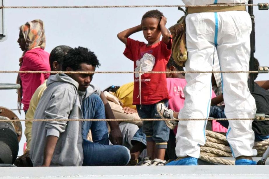 Migrants disembark from the Italian military ship "Sfinge" in the port of Augusta, on the eastern coast of Sicily.