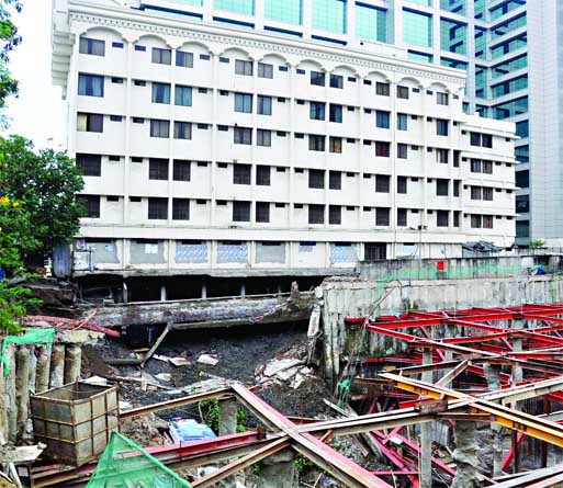 A road adjacent to Sundarban Hotel at Karwanbazar in city caved in into construction site of a building on Wednesday morning. Electric poles and WASA line were also disrupted in the area.