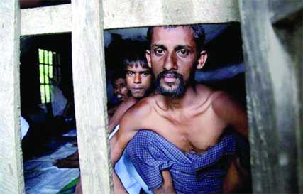 Rohingya Muslims from Bangladesh rescued by the Myanmar navy sit inside buildings at a temporary refugee camp in the village of Aletankyaw in the Maungdaw township of northern Rakhine state.