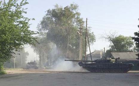 A tank drives along a street of the Russian southern town of Matveev Kurgan, near the Russian-Ukrainian border in Rostov region, Russia.