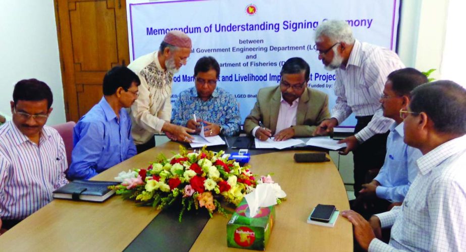 LGED Chief Engineer Shyama Prosad Adhikari and Fisheries Department Director General Dr Syed Arif Azad sing a Memorandum of Understanding to provide technology and training supports to the landless people in the Haor area at LGED head office in the city o