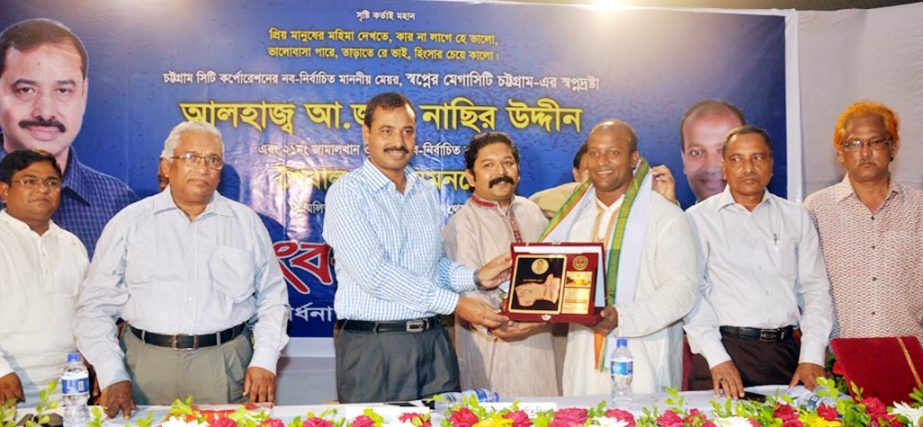 CCC Mayor AJM Nasir Uddin handing over crest to the newly-elected Councilor Soibal Das Sumon at a reception ceremony ar Jamal khan ward in the city yesterday.