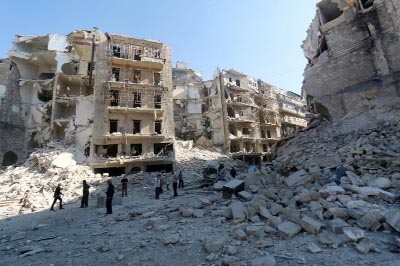 Civilians stand amid destroyed buildings in the eastern Shaar neighbourhood of the northern Syrian city of Aleppo on Saturday.